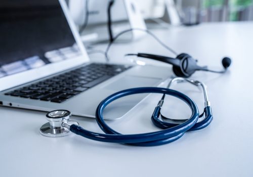 Headset and doctor equipment at clinic ready for actively support for patient by online video call . Concept of telehealth and telemedicine service .
